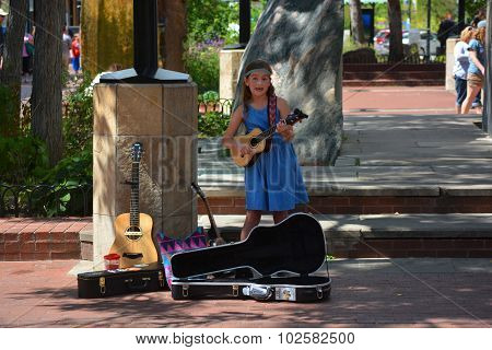 Young Girl Busking Playing Guitar