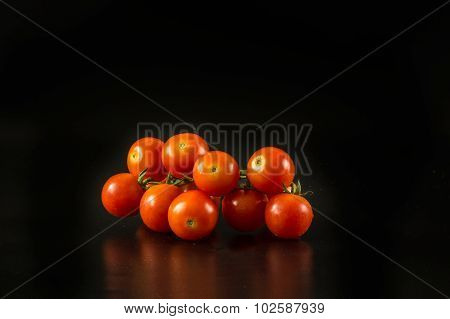 Fresh Cherry Tomatoes On The Black Background