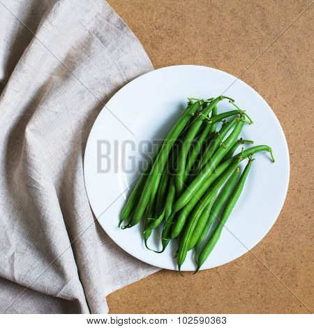 Green Beans On A White Plate On A Table With A Napkin