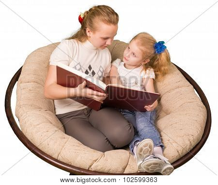 Two sisters reading book