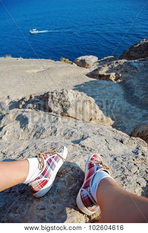 Overhead photo of feet on a background of seaview. Women feets view from above. Exploring, travellin