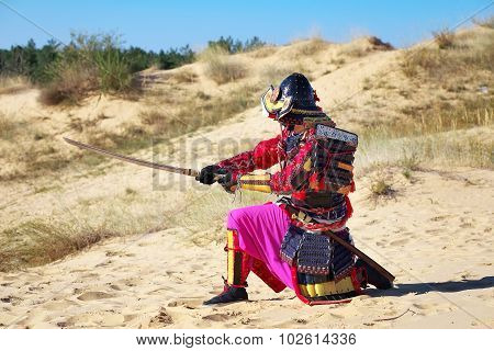 Samurai With Sword On The Sand. Men In Samurai Armour On The Sand. Original Character
