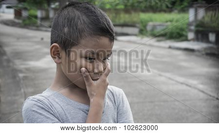 Young Asian boy thinking