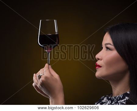 Asian sommelier woman with glass of red wine