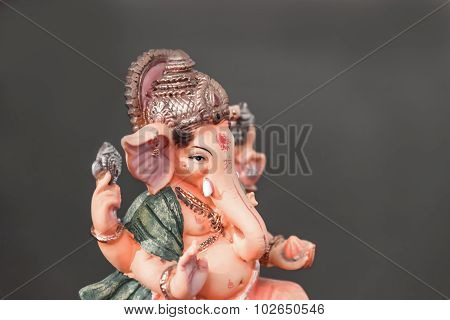 Orange Ganesh (ganapati- Elephant God) In Hindusim Mythology Closeup Hold The Weapons Maze And Axe P