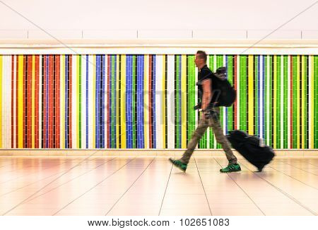 Man Walking At International Airport With Suitcase And Backpack - Alternative Travel Lifestyle