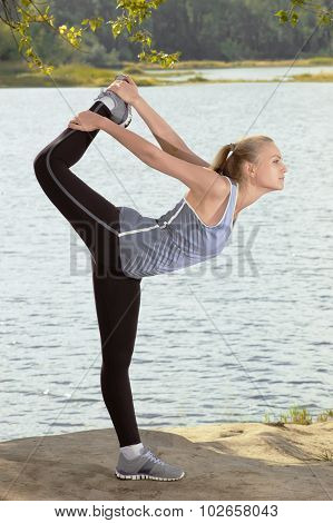 Beautiful Young Blonde Woman With Athletic Body Doing Stretching Exercise Outdoors