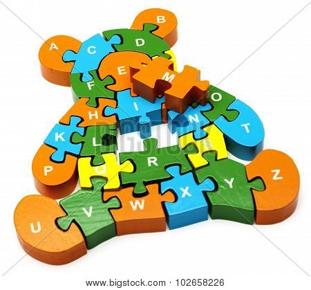 wooden colored puzzle in bear form with letters