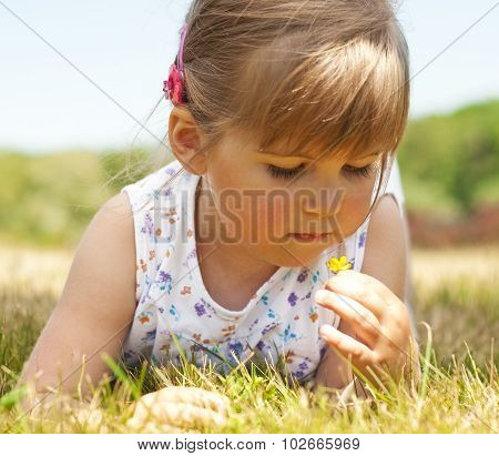 Little girl lying on grass in the park