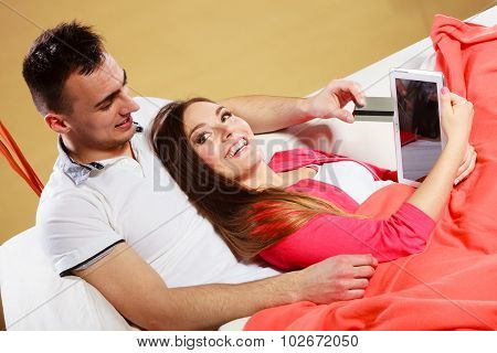 Young Couple With Tablet And Credit Card At Home