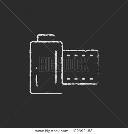 Camera roll hand drawn in chalk on a blackboard vector white icon isolated on a black background.