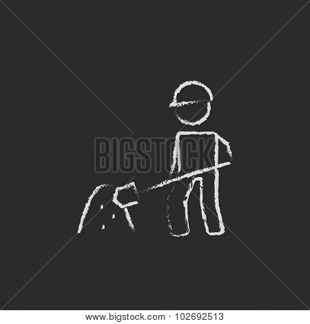 Man with shovel and sand hand drawn in chalk on a blackboard vector white icon isolated on a black background.