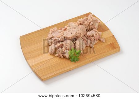 chunks of tuna on wooden cutting board
