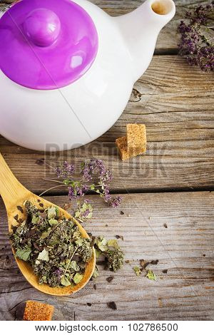 Dry Herb Tea In A Wooden Spoon And White Teapot