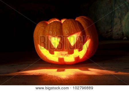 Bright Light In Pumpkins On Wood And Pumpkins Background By Dark Light Tone.