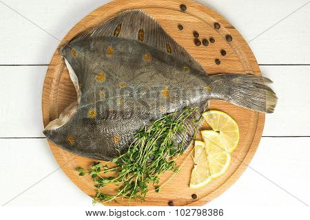 Crude Flatfish With Lemon, Thyme And Pepper On The Board