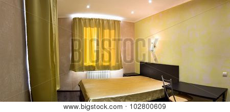 Bed In A Bedroom In Shades Of Yellow