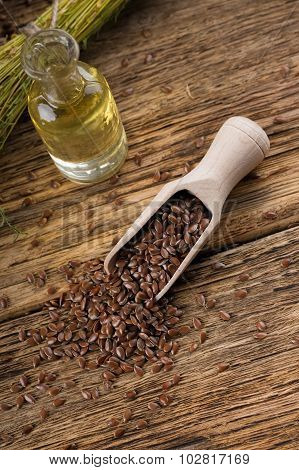 Spilled Flax Seeds From Wooden Spoon On Old Table
