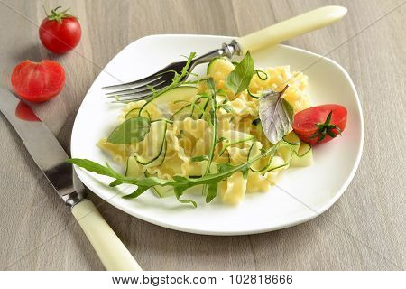 Italian pasta noodles with zucchini arugula basil