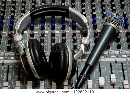 Microphone And Headphone On The Sound Mixer Background.