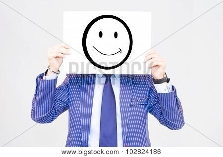 Business Man Hoding Card With Happy Face On Grey Background
