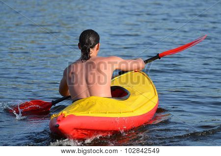 a man in a boat canoe floating on the river quickly