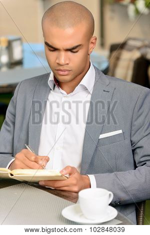 Handsome businessman making notes