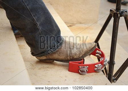 Musician Are Using A Foot Knocked Tambourine