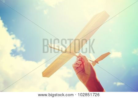 Toy balsa wood airplane in the sky. Toned filtered Instagram image