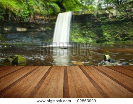 Beautiful Woodland Stream And Waterfall In Summer With Wooden Planks Floor