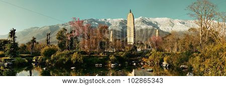 Ancient pagoda in Dali old town with snow capped Mt Cangshan, Yunnan, China.