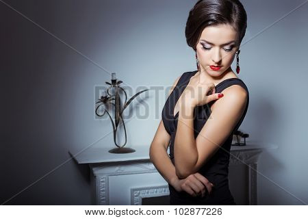 beautiful elegant attractive sexy girl in evening dress with hairstyle and bright makeup is evening