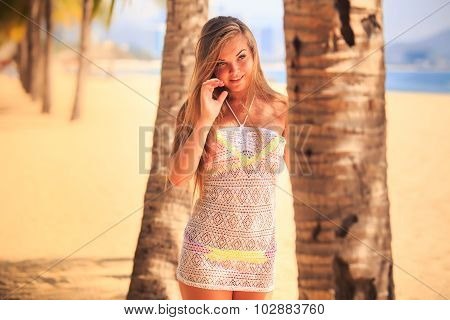 Blonde Girl In Lace Closeup Stands At Palm On Beach
