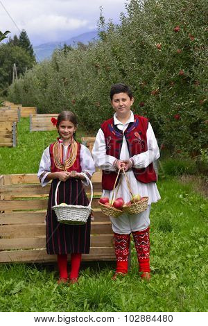 Resen, Macedonia. September, 27  2015- Boy And Girl In Traditional Clothes Posing With Apples During