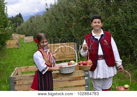 RESEN MACEDONIA. 27 SEPTEMBER 2015- Boy and girl in traditional clothes posing with apples during festival Prespa apple picking 2015 in Resen Macedonia
