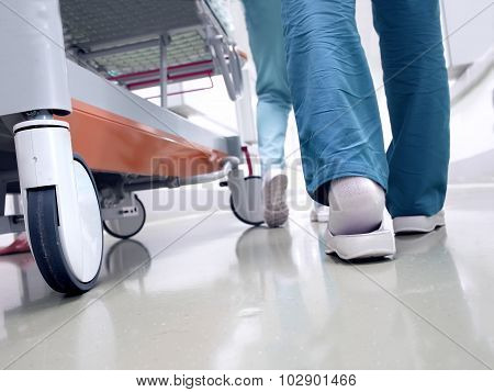 Medical Staff Moving Patient Through Hospital Corridor