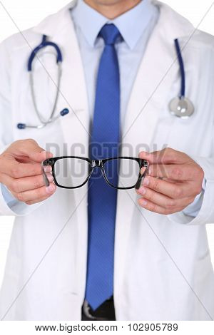 Male Medicine Doctor Hands Giving Pair Of Black Glasses To Patient