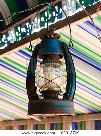 The Old Lamp Hangs On Beam Colorful Blur Background.