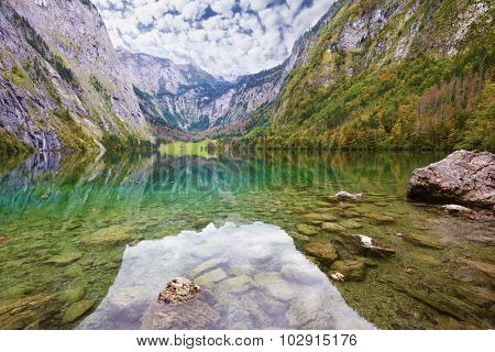 Fabulously beautiful lake Koenigssee in Austria. Mountainous lakeside reflected in the smooth water of the lake, like the wings of butterfly