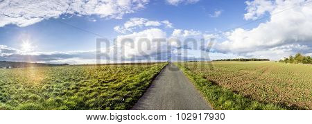 rural landscape with fields and clouds in bright sunset