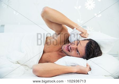 Man in the bed angry about noise at home