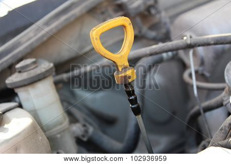 The Oil Dipstick Of A Car Engine