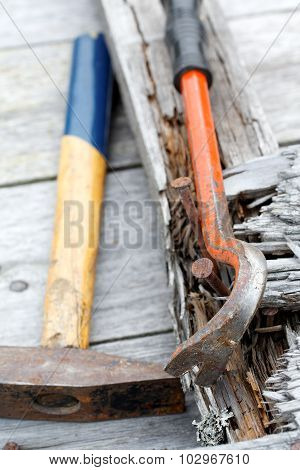 Claw Hammer And Rusty Nails On The Old Boards