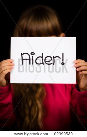 Child Holding Sign With French Word Aider - Help