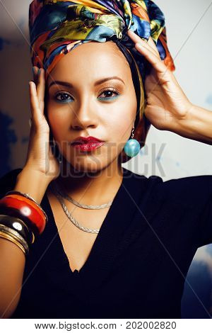 beauty bright african woman with creative make up, shawl on head like cubian  closeup