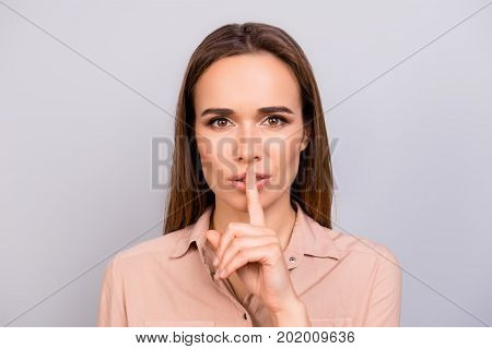 Shh! Keep My Secret. Attractive Young Brunette Woman In Beige Formal Shirt Is Showing Someone To Kee