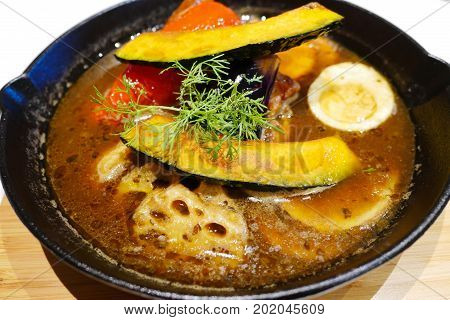 Soup curry with chicken and vegetables japanese original bowl of Hokkaido. Hot and spicy asian menu.