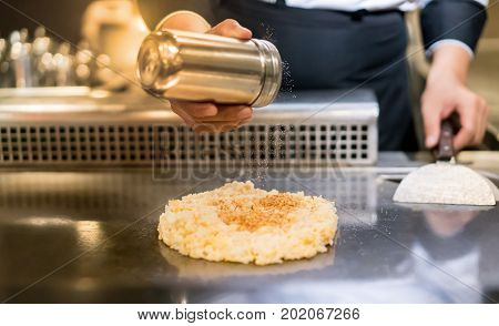 Hand Of Chef Cooking Garlic Fried Rice On Hot Pan In Front Of Customers.