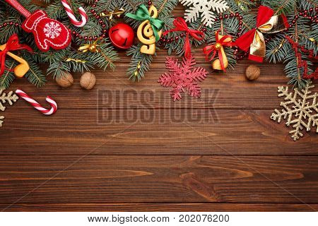 Beautiful composition with fir tree branches and decorations on wooden background. Christmas music concept