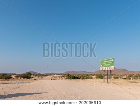 A directional sign and distance sign on the C40-road between Kamanjab and Palmwag in the Kunene Region of Namibia
